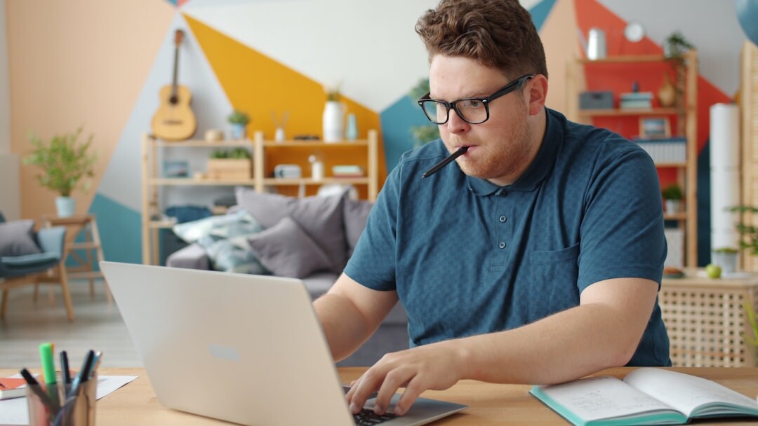 Student studying online with laptop at home